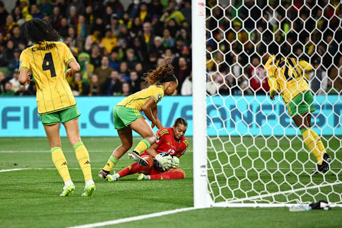Jamaica goalkeeper Rebecca Spencer pictured (center) holding the ball during her team's 0-0 draw with Brazil at the 2023 FIFA Women's World Cup